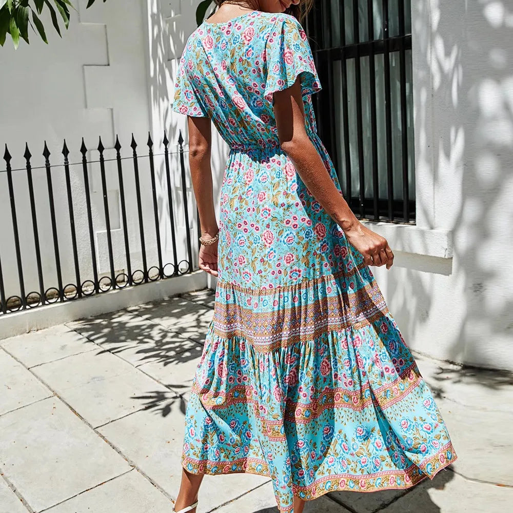 Back view of a tiered midi dress with V-neck and short butterfly sleeves