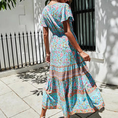 Back view of a tiered midi dress with V-neck and short butterfly sleeves