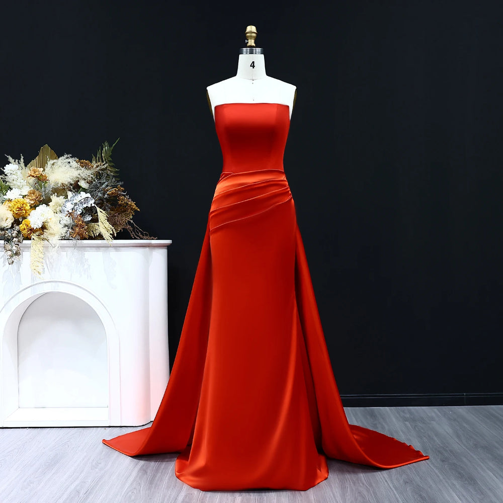 Red evening gown on a mannequin against a black background