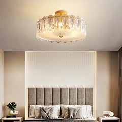 Modern bedroom with a crystal ceiling light fixture, bed, and nightstands.