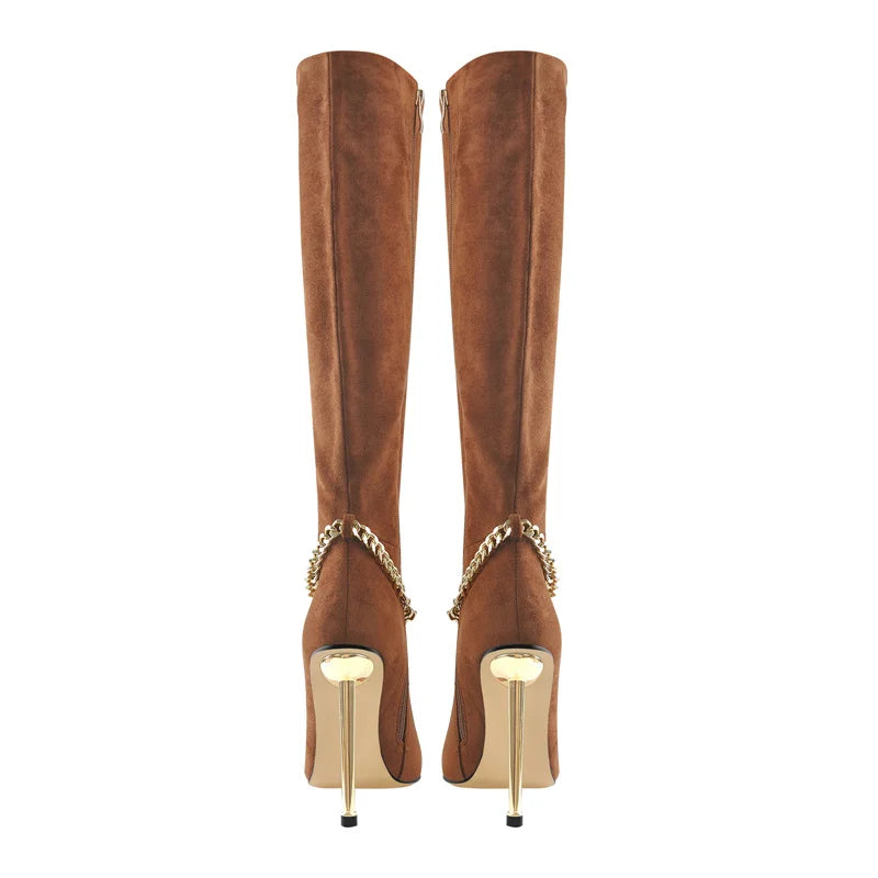 Back view of a pair of brown pointed toe knee-high boots with gold chain accents and stiletto heels