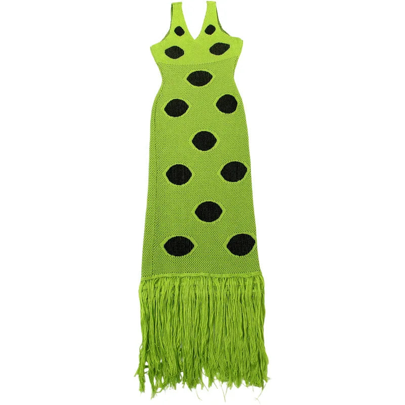 Green dress with black polka dots and fringes on a white background