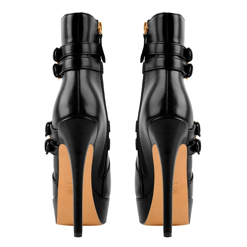 Rear view of black faux leather platform stiletto ankle boots showing the stiletto heel and sole.