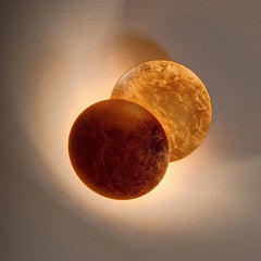 Two round, textured wall lights on a neutral background
