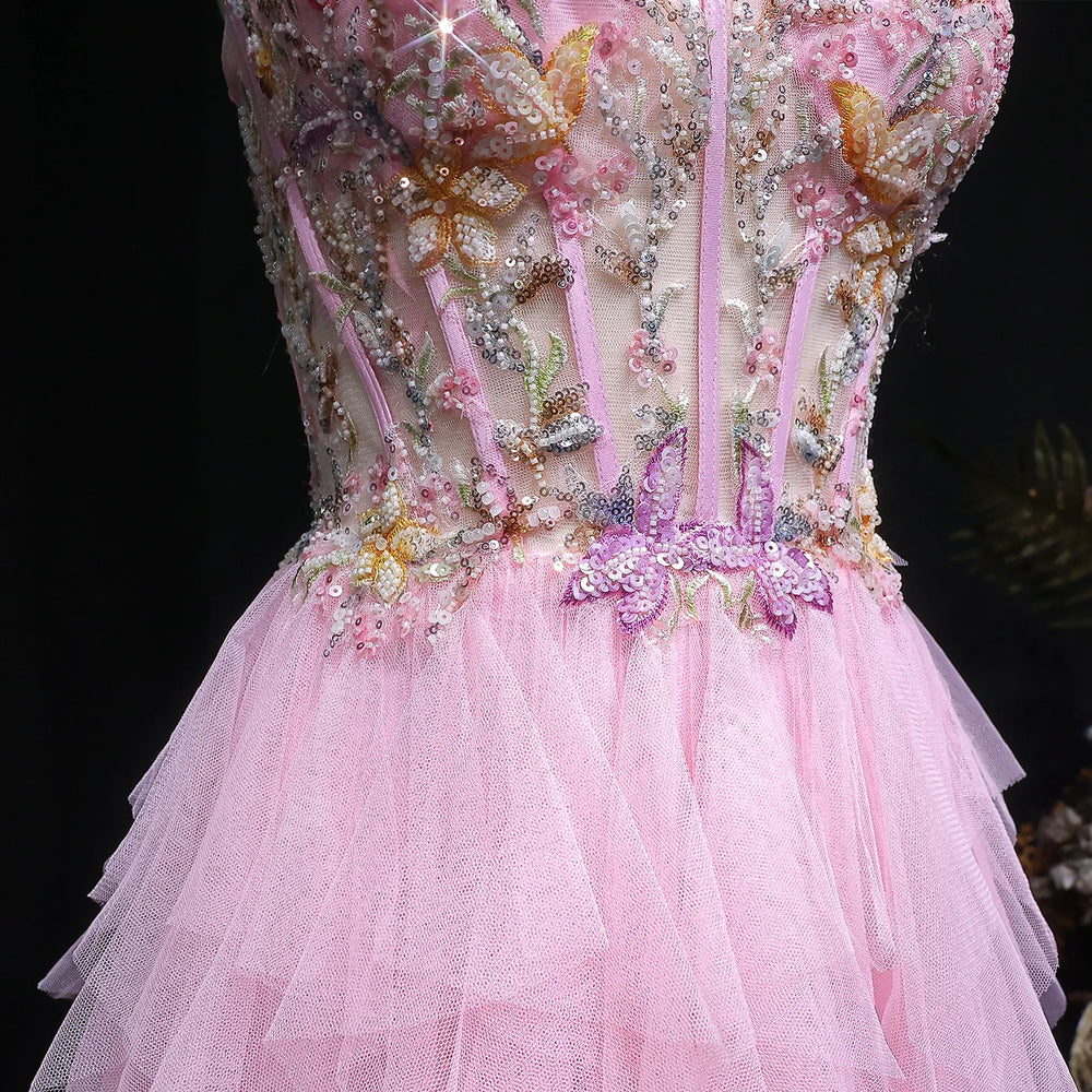 Pink dress with intricate beadwork and floral details on a black background