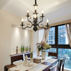 Dining room with a chandelier, table setting, and city view.