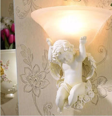 A beautiful beige angel wall lamp with LED light, adding a touch of elegance to a living room. Golden Atelier 7