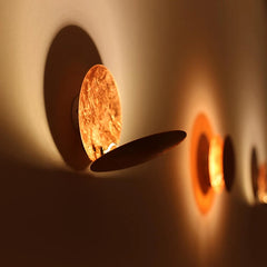Close-up of a wall-mounted light fixture with a warm glow.