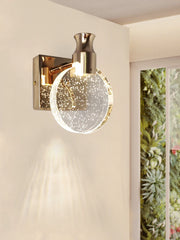 Wall-mounted lamp with a decorative glass shade in a room setting.