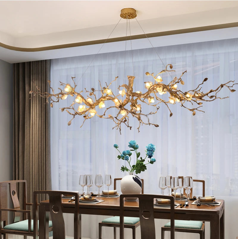 Dining room with a decorative chandelier, table set for dinner, and floral arrangement.