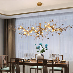 Dining room with a decorative chandelier, table set for dinner, and floral arrangement.