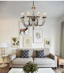 Vintage wood chandelier with multiple lights and a distressed finish, hanging in a rustic living room. Golden Atelier 3