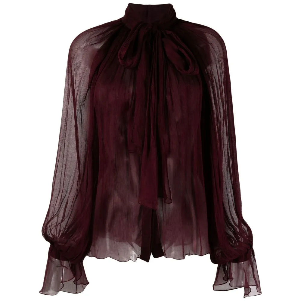 Sheer burgundy blouse with a tied neckline on a white background