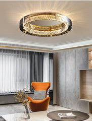 Modern ceiling light fixture in a stylish room with an orange chair and decorative elements.