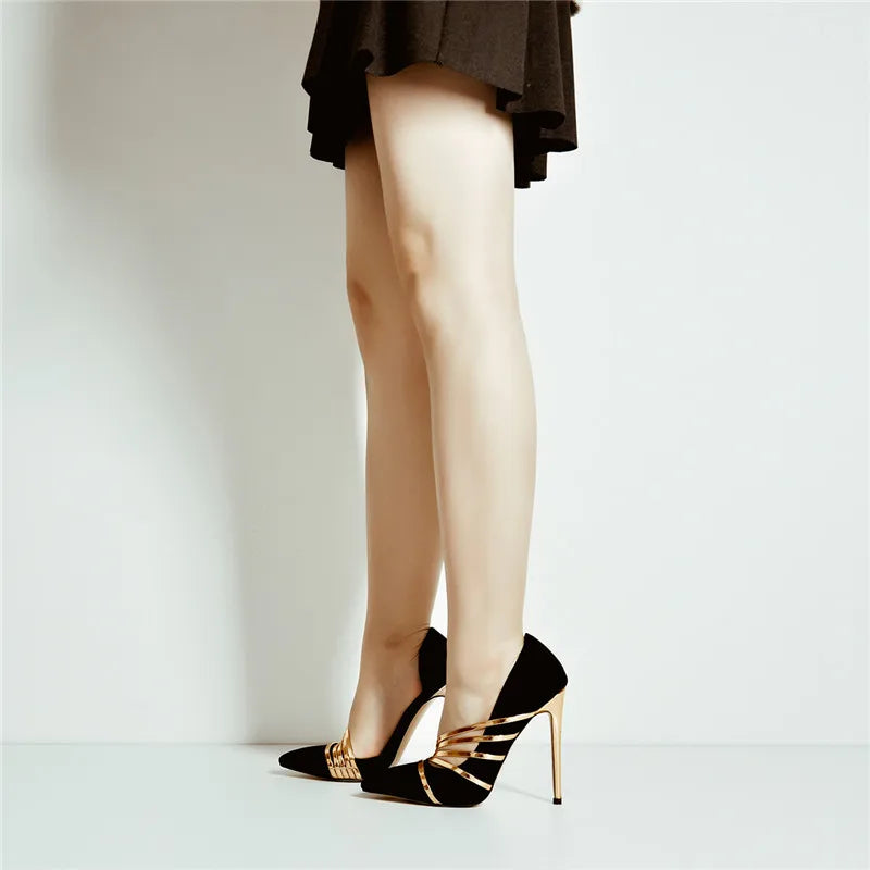 Model wearing black pointed toe stiletto heels with gold accents