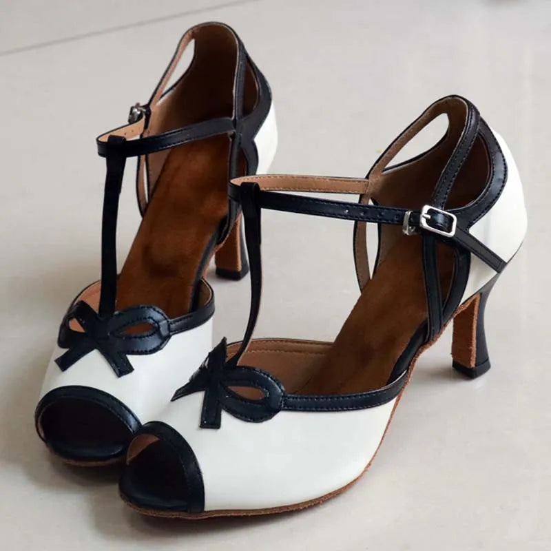 Side view of white and black T-strap dance heels