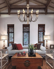 Vintage wood chandelier with multiple lights and a distressed finish, hanging in a rustic living room. Golden Atelier 2