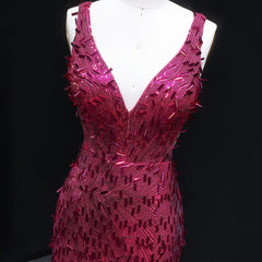 Pink sequin dress on a mannequin against a black background