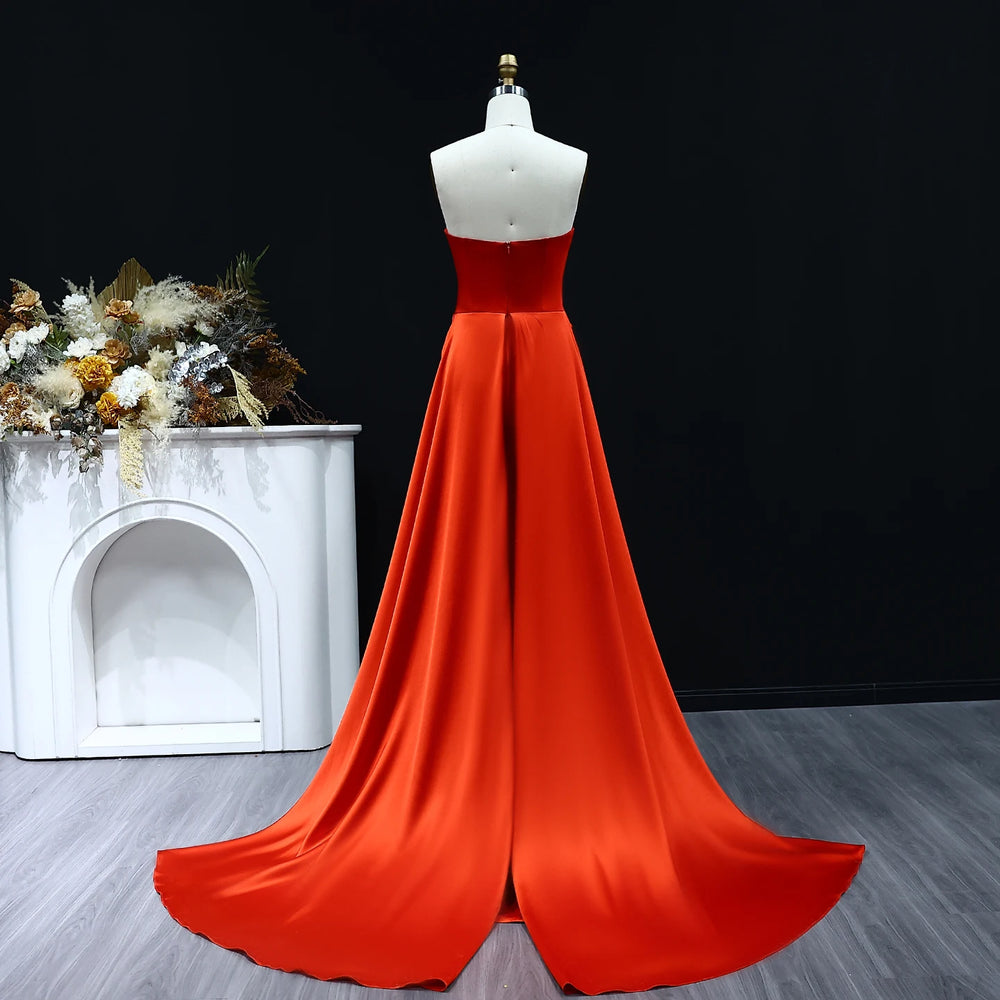 Red evening gown on a mannequin against a black background