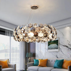 A stunning crystal chandelier with a wrought iron frame, hanging above a living room table.