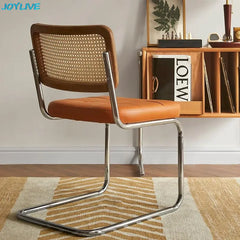 Golden Atelier living room chairs made from solid wood with a modern rattan design and comfortable armrests. Orange 3