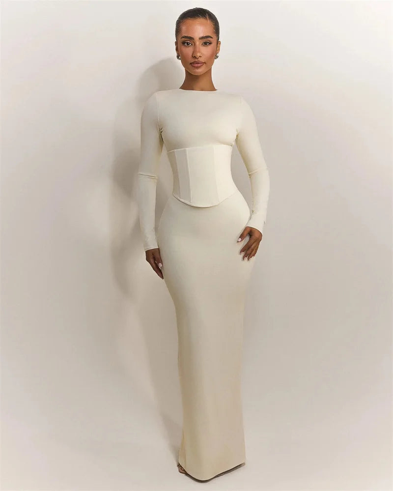 Full-length view capturing the smooth bodycon fit and floor-length fall against a soft studio backdrop.