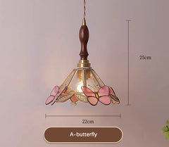 Decorative pendant light with butterfly design and measurements on a plain background