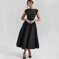 Black dress worn by a model on a white background