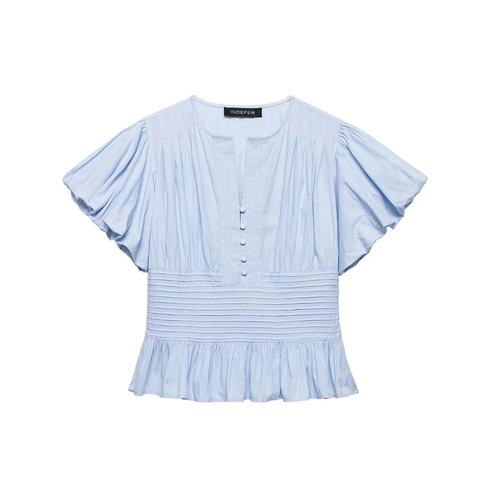 Light blue blouse with ruffled sleeves on a white background