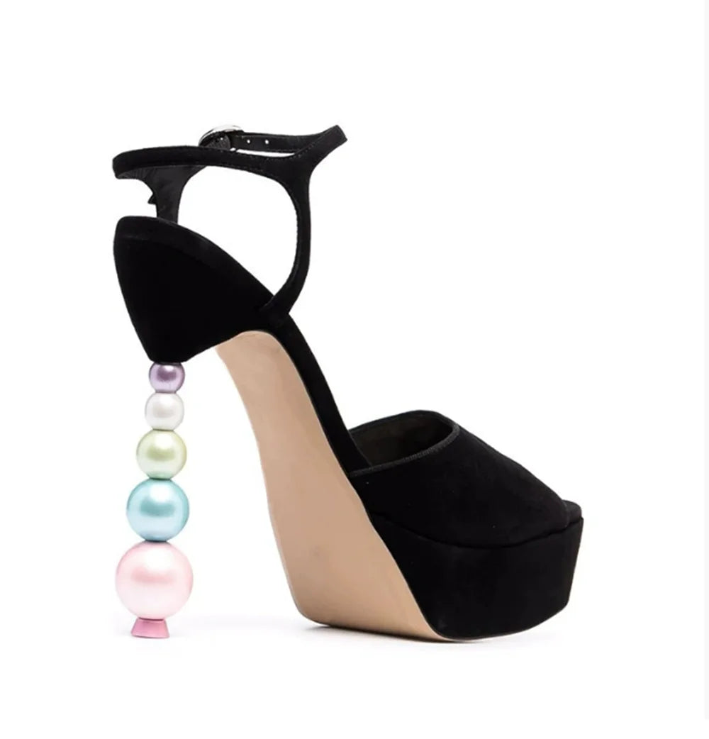 Black suede platform sandal with a pastel-toned beaded stiletto heel.