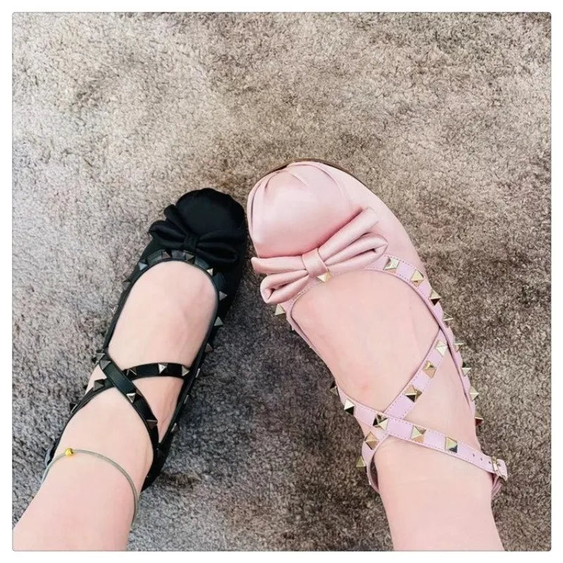 Comparison of black and pink studded ballet flats with bow detail.