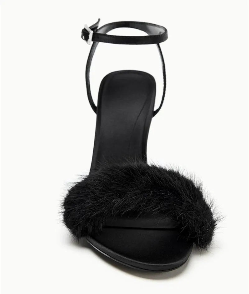 Close-up of black faux fur strap on stiletto heel sandal