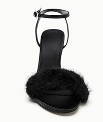Close-up of black faux fur strap on stiletto heel sandal