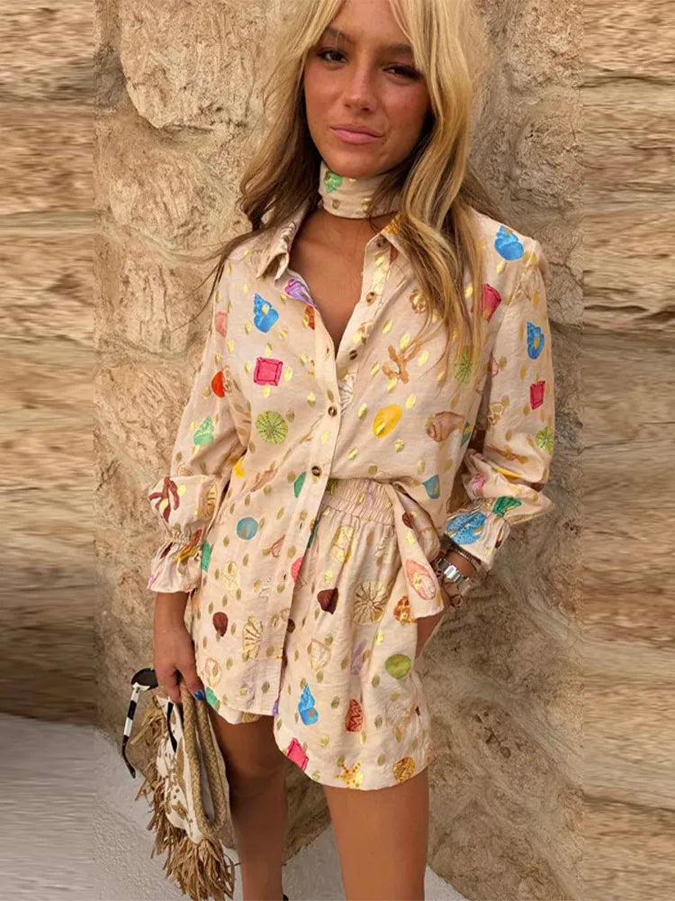 Woman wearing a patterned dress against a stone wall.