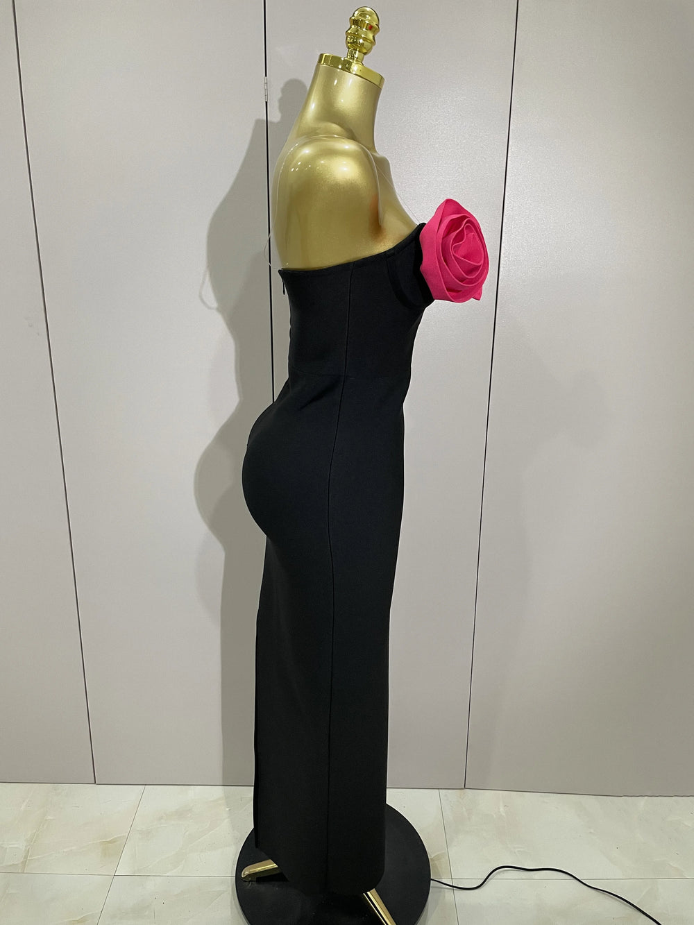 Black strapless ankle-length dress with appliques.