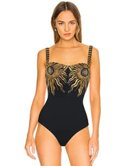 Black swimwear set with ornate gold sunburst embellishments on the bodice and skirt