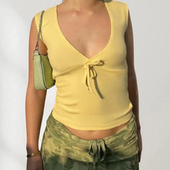 Person wearing a yellow top and green pants with a white background