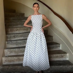 Woman in a polka dot dress standing on a staircase