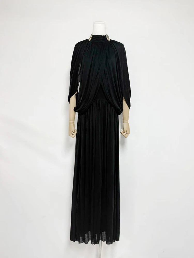 Black evening gown on a mannequin against a white background