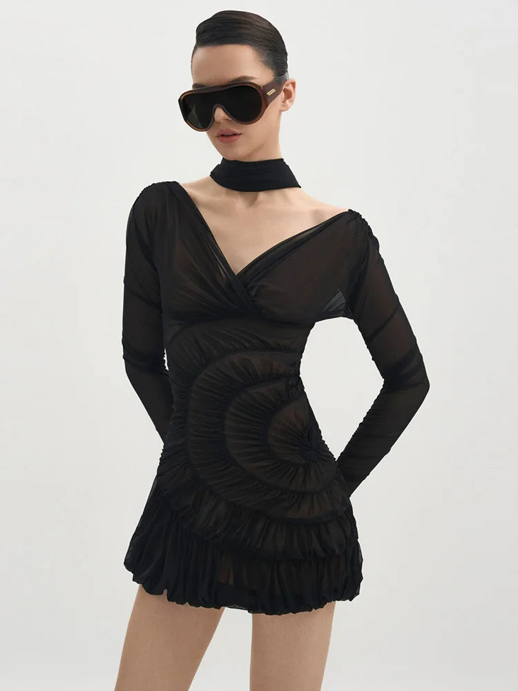 Black dress with long sleeves and a high neckline on a white background