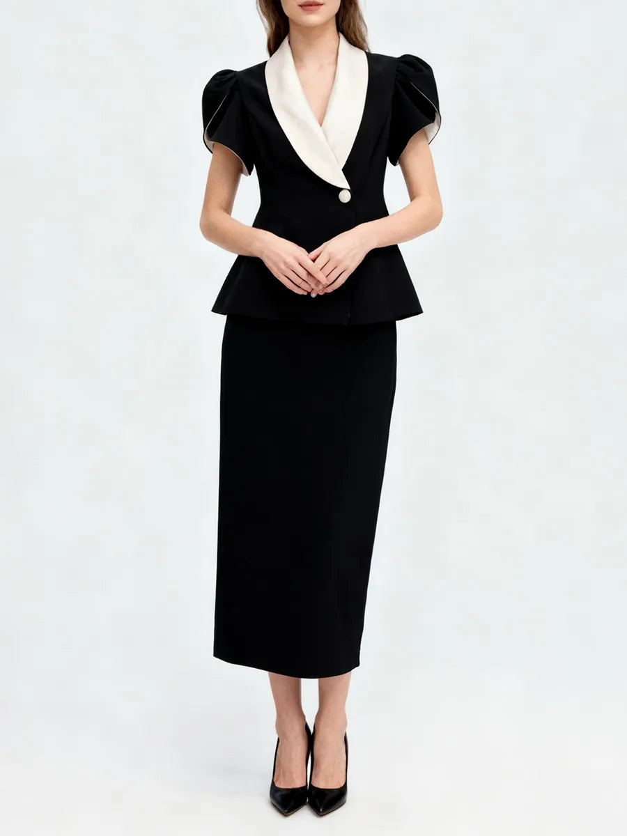 Black tunic top with lapel and high waist skirt styled for formal wear
