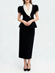 Black tunic top with lapel and high waist skirt styled for formal wear
