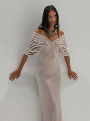 Detail of the ruched sleeve and off-shoulder neckline on a maxi dress.