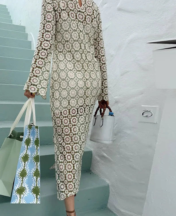 Person wearing a patterned outfit with a white vehicle in the background