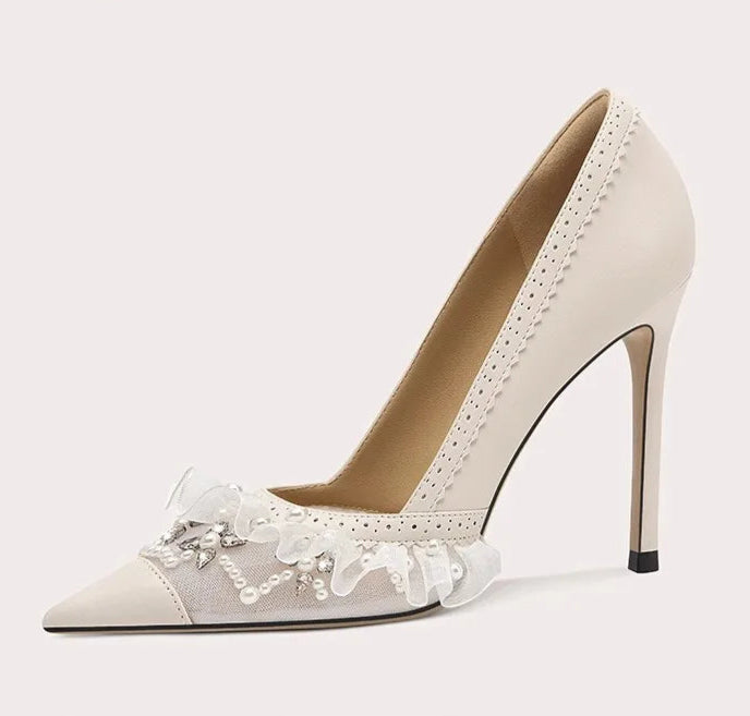 High-heeled shoe with lace details on a light gray background