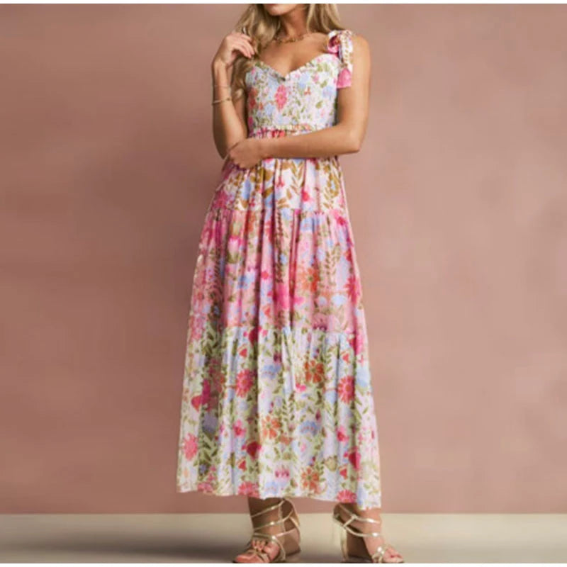 Person wearing a floral smocked bust tie strap maxi dress.