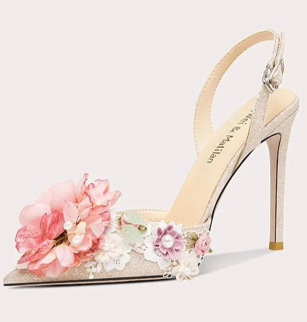 High-heeled sandal with floral decorations on a light gray background