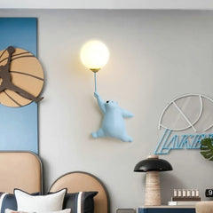 Golden Atelier LED wall lamp in the shape of a friendly cartoon bear, mounted on a wall in a child's room and casting a soft glow. Blue Bear