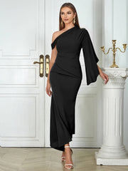 Woman wearing a black one-shoulder dress in an elegant interior setting.