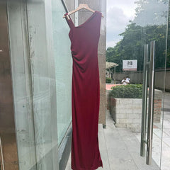 Red one-shoulder ruched maxi dress displayed in storefront